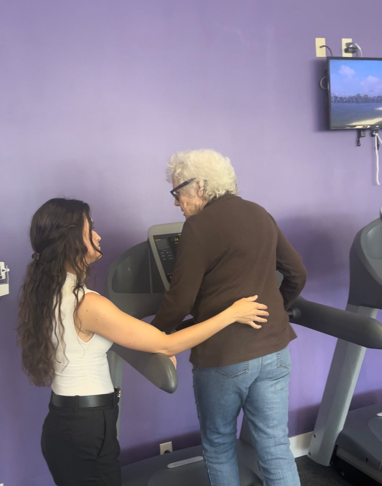 Dr. Tyler Joiner spotting a patient on a treadmill