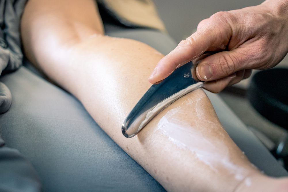 Instrument-assisted muscle scraping on a forearm